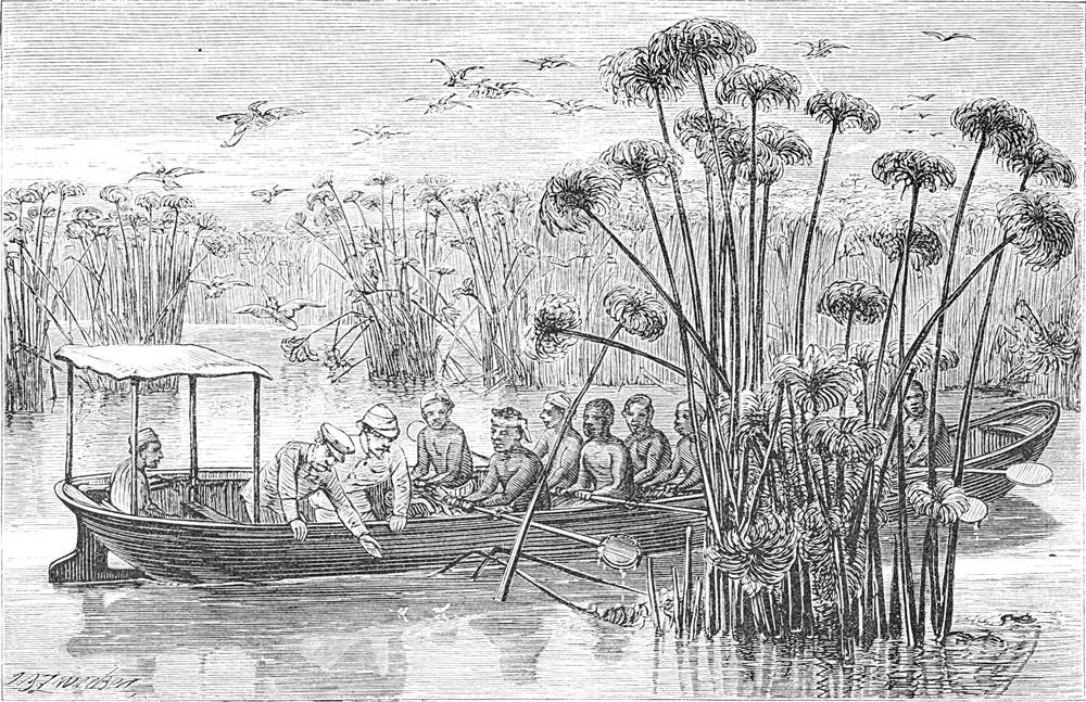 Die Expeditionsteilnehmer
  sitzen in einem Ruderboot auf einem Fluss